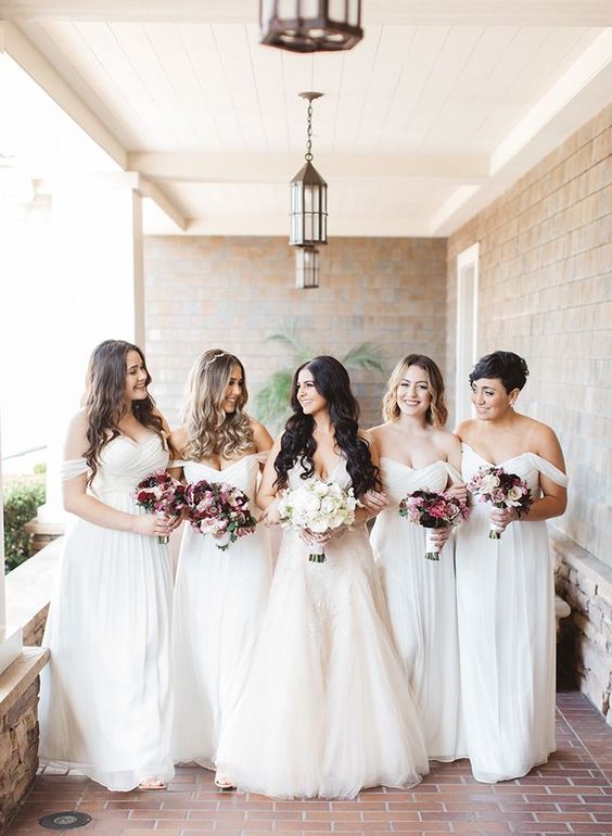 refined white off the shoulder maxi bridesmaid dresses with draped bodices and skirts for a chic neutral wedding