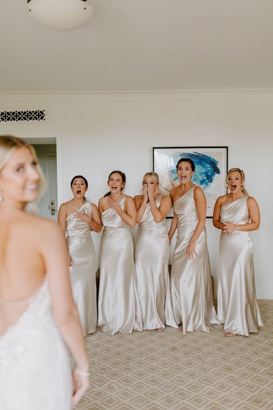 silver satin one shoulder maid bridesmaid dresses are a cool neutral idea for a glam wedding, and the bride in white will stand out