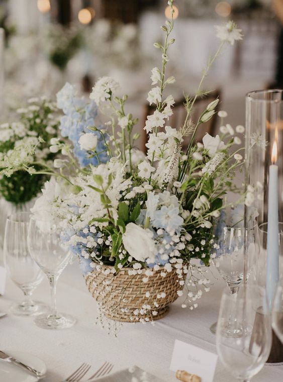 a basket with white and blue blooms, baby's breath and astilbe is a cool idea for spring or summer