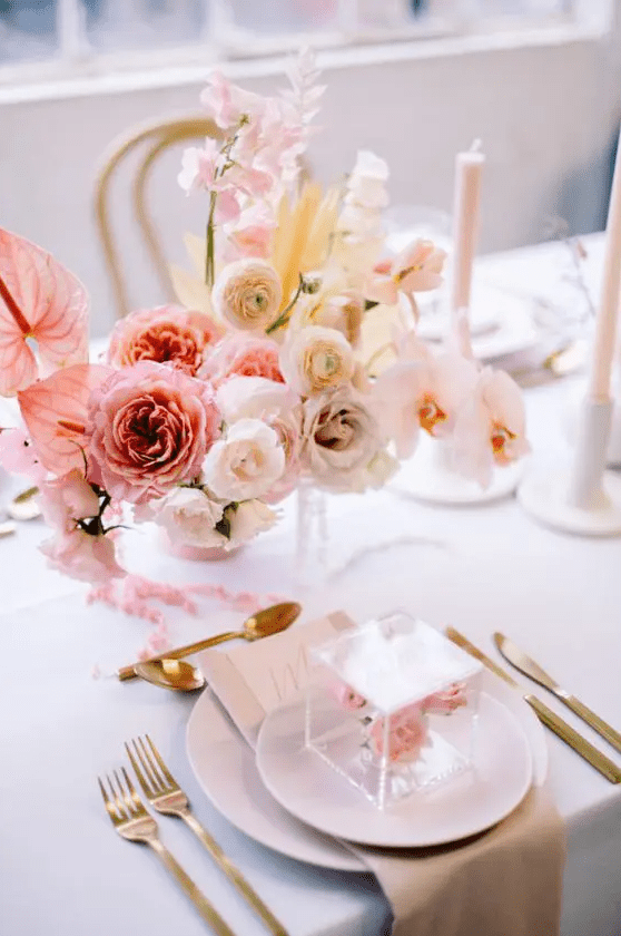 a beautiful ombre floral wedding centerpiece of pink, blush and white blooms with a pretty shape is great for Valentine's Day