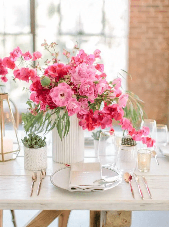 a beautiful wedding centerpiece of bougainvillea, with cacti and succulents around is a colorful idea for a wedding