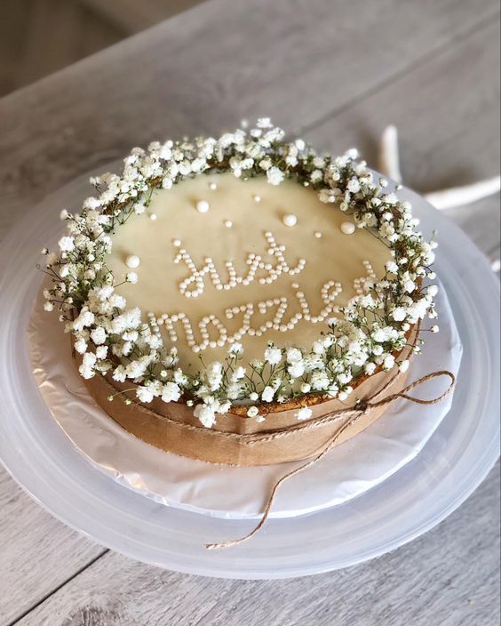 a cheesecake wedding cake decorated with baby's breath and letters is a cool idea for those who don't like sweets
