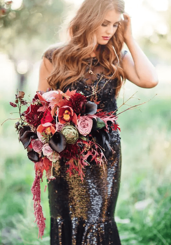 a colorful wedding bouquet with pink, hot pink and black callas plus cascading blooms and leaves