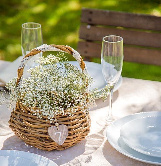 a cute basket wedding centerpiece of baby's breath is a lovely idea for any spring or summer wedding inrustic style