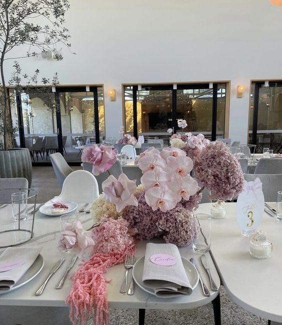 a delicate neutral wedding centerpiece of lavender hydrangeas, blush orchids and roses, pink amaranthus is amazing