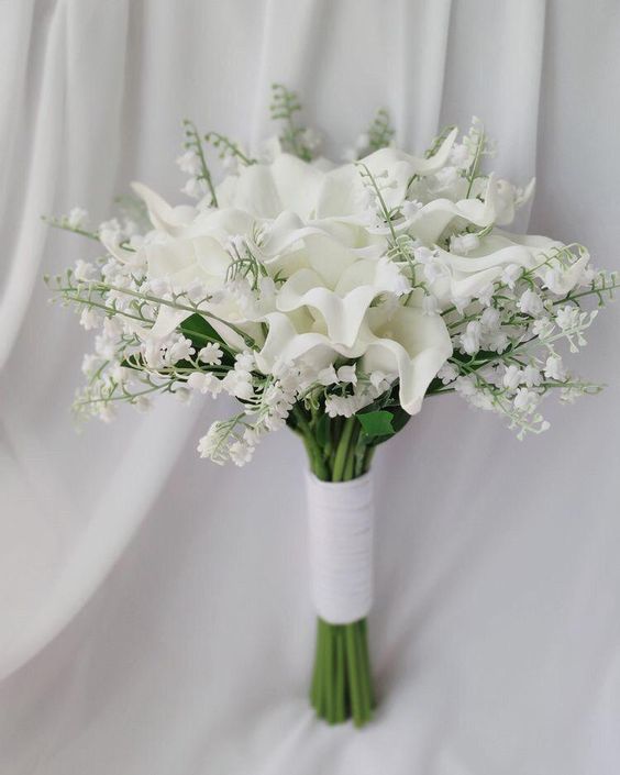 a fab spring wedding bouquet of white callas and lily of the valley is a fresh and cool idea for a spring bride