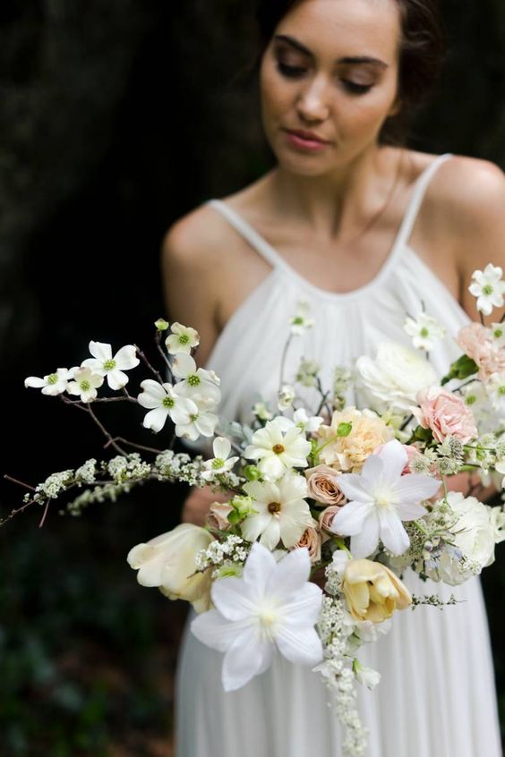 a fine art wedding bouquet of roses, tulips and fillers is a cool and chic idea for a spring wedding done in neutrals