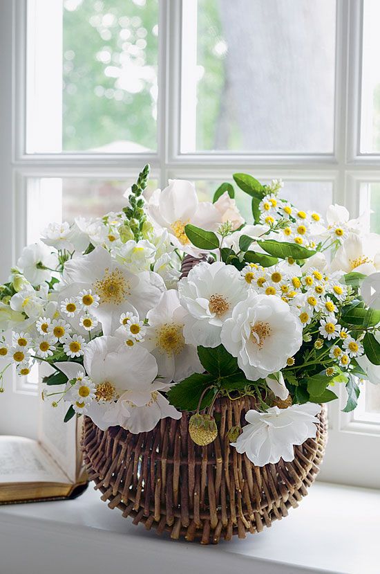 a fresh spring or summer wedding centerpiece of white blooms and greenery is a fresh and cool idea