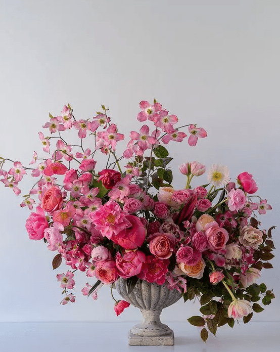a gorgeous statement-like Valentine's Day wedding centerpiece of pink and neutral blooms and some greenery