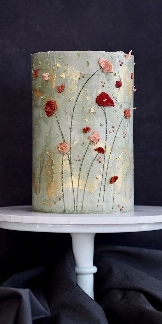 a grey green tall wedding cake with sugar blooms in pink and red is a cool idea for a summer or fall garden wedding