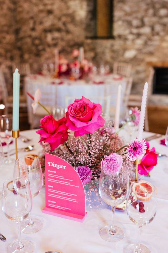 a lovely modern pink wedding centerpiece of pink carnations and roses and pink baby's breath is a super cool idea
