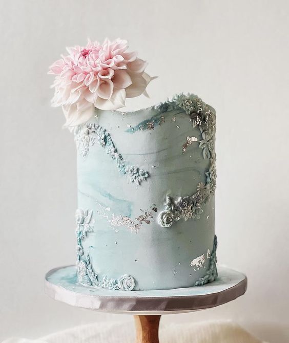 a mint blue watercolor wedding cake with sugar blooms and a pink dahlias on top is a cool idea for a spring wedding