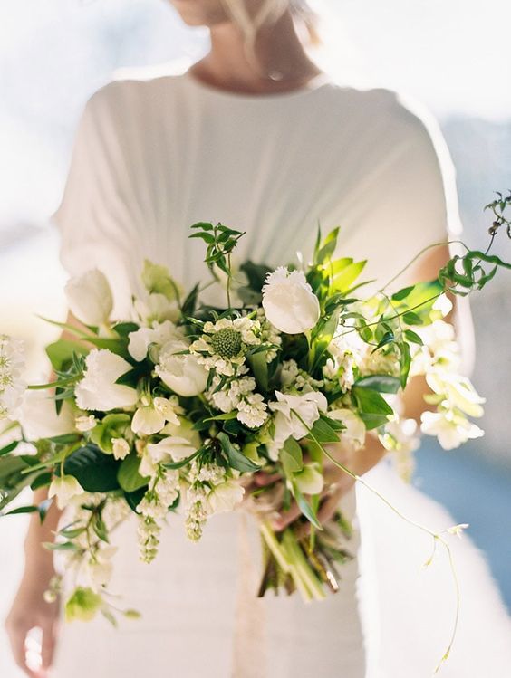 a modern wedding bouquet of white tulips, white sweet peas and fillers and greenery for a modern or casual spring bride