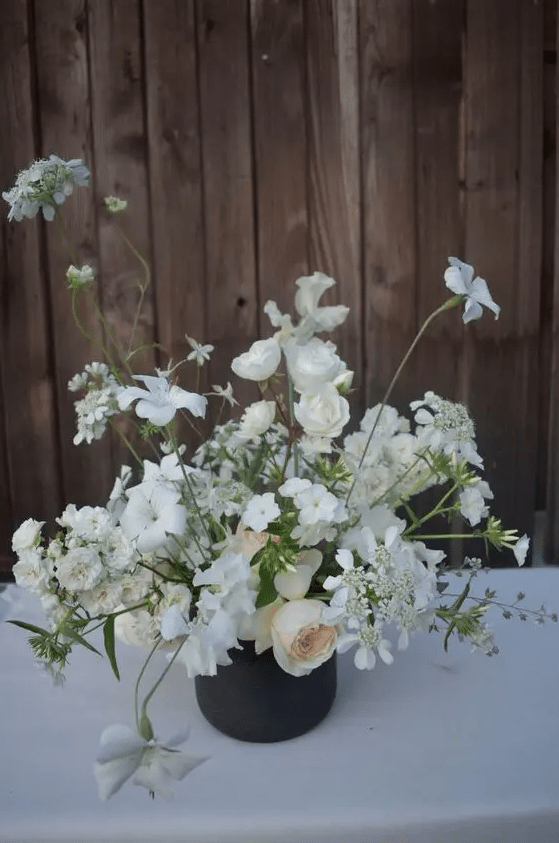 a neutral wedding centerpiece of blush peonies, white roses and sweet peas is a lovely idea for a modern neutral wedding