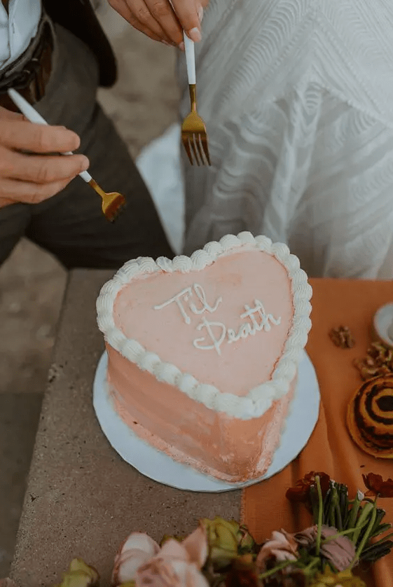 A peachy pink heart shaped wedding cake with sugar details is a lovely idea for a modern wedding