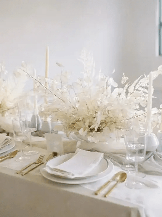 a really ethereal dried leaf wedding centerpiece with lunaria is ideal for an all-white wedding tablescape and it looks chic and elegant