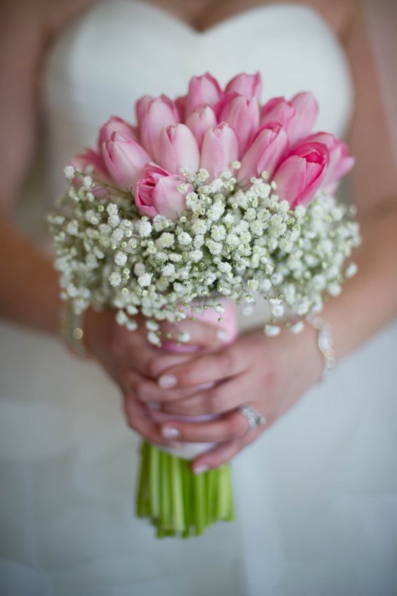 a rustic spring wedding bouquet of pink tulips and baby's breath is a lovely idea for a rustic or cowboy bride