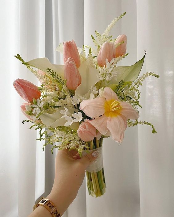a spring wedding bouquet of white callas, pink tulips and other blooms and some astilbe is a lovely idea for a wedding