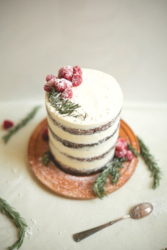 a tall naked wedding cake with fresh berries and herbs is a cool idea for a modern wedding in winter