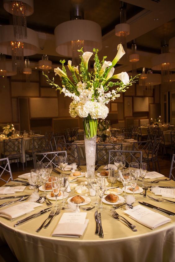 a tall wedding centerpiece of white hdyrangeas, callas and delphinium is a chic and bold idea for a modern wedding