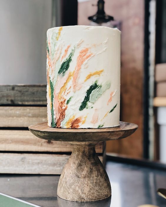 a tall white wedding cake with painted sugar watercolors is a lovely idea for a spring or summer wedding