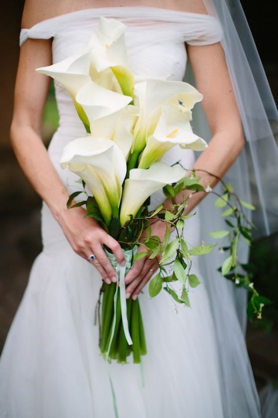 a textured calla wedding bouquet with greenery cascading is amazing for a modern bride
