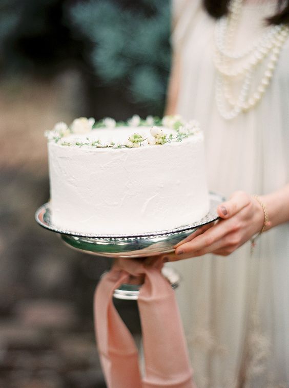 a white textural wedding cake with fresh berries is a cool idea for spring and summer, it looks cool, fresh and nice