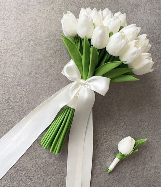 a white tulip wedding bouquet with a white ribbon bow is timeless classics for a spring wedding, great for a modern or minimal one