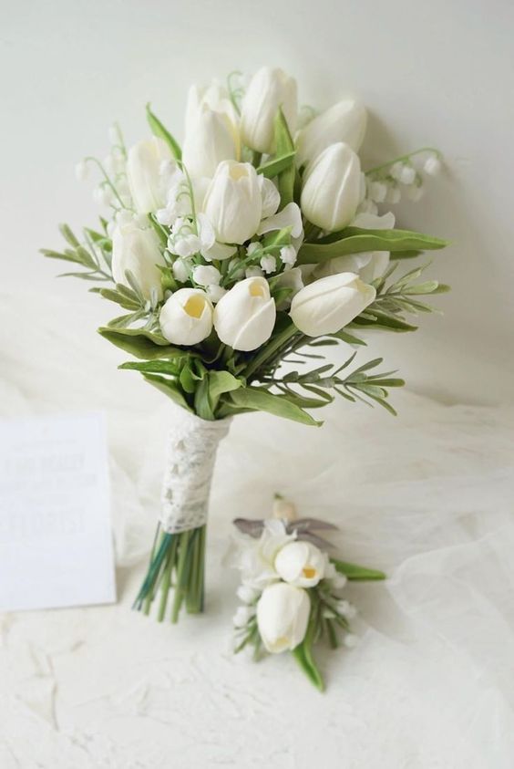 a white wedding bouquet of tulips and lily of the valley is an adorable idea for a spring wedding