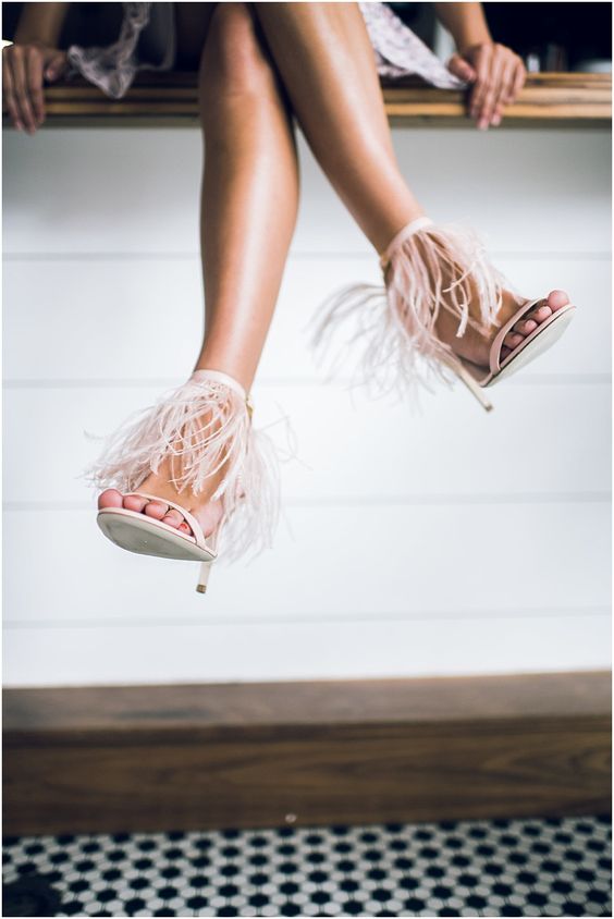 blush wedding heels with feather ankle straps are a unique and catchy idea for a bridal look