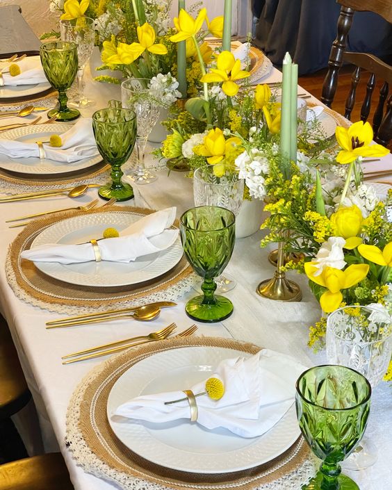 bold yellow wedding centerpieces of tulips white fillers and greenery and green candles are amazing for spring and summer