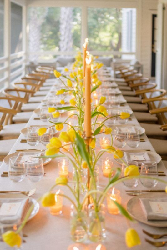 bright yellow cluster wedding centerpieces paired with yellow candles are a perfect combo for a bright spring wedding