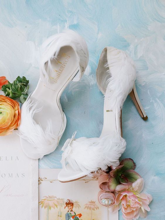 classy white feather wedding shoes with peep toes and high heels are amazing for an art decor bridal look