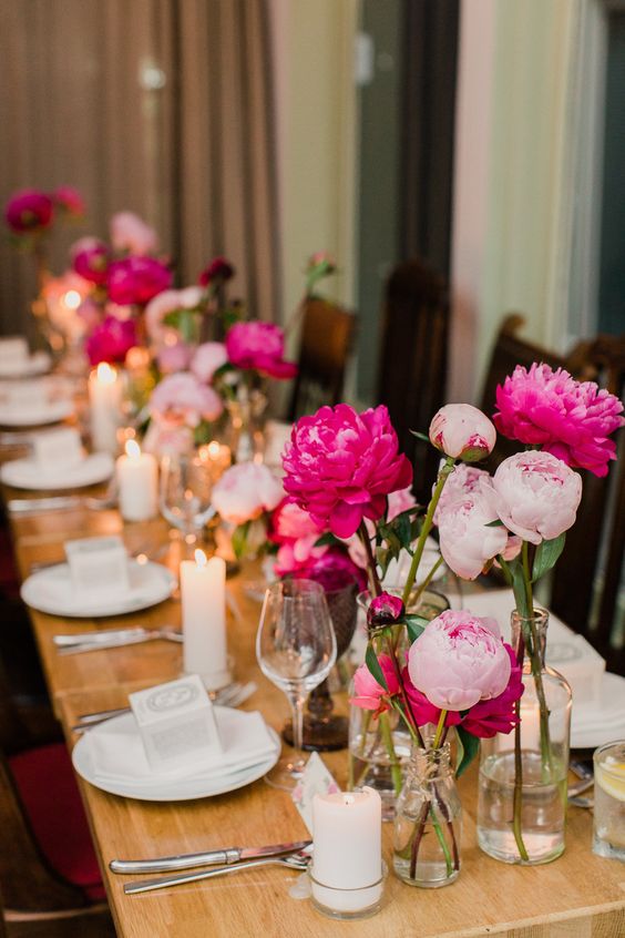 cluster pink wedding centerpieces of peonies plus candles are a lovely combo for a casual wedding
