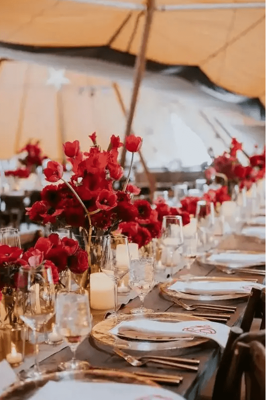 cluster red floral wedding centerpieces paired with elegant candles will make up a super chic wedding tablescape