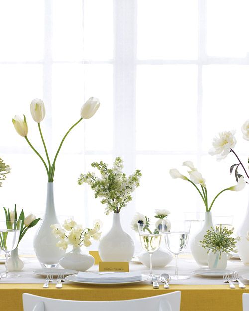 cluster wedding centerpieces of white vases, white tulips, peonies, anemones and other blooms for an all-white wedding