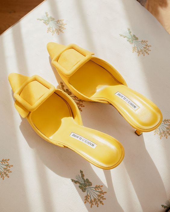 edgy yellow mules with comfy heels and buckles will give a fashionable feel to your look