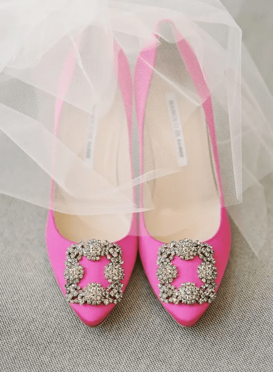 hot pink Manolo Blahnik shoes with gold rhinestone buckles are classics for a wedding