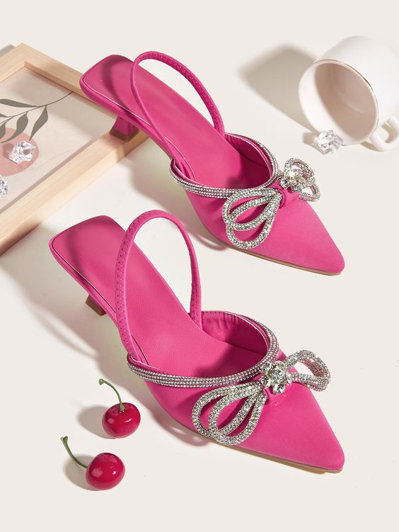 hot pink wedding mules with kitten heels and silver bows and straps are perfect for a chic and glam bridal look at a wedding