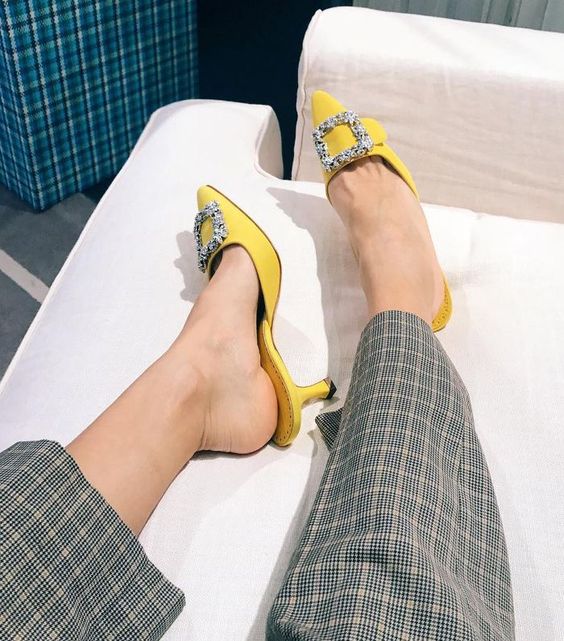 lemon yellow heeled mules with embellished buckles are classics by Manolo Blahnik