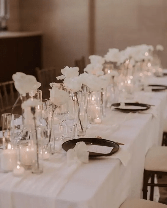 modern cluster wedding centerpieces of white roses and small candles are a chic and lovely idea for a modenr sophisticated wedding