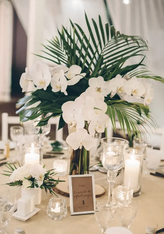 palm leaves and white orchids are a classic and chic combo for any modern tropical wedding with a neutral color palette