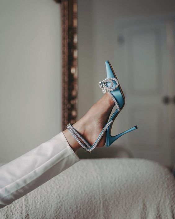 refined and glam blue wedding shoes with embellished bows and high heels for a bold bridal look