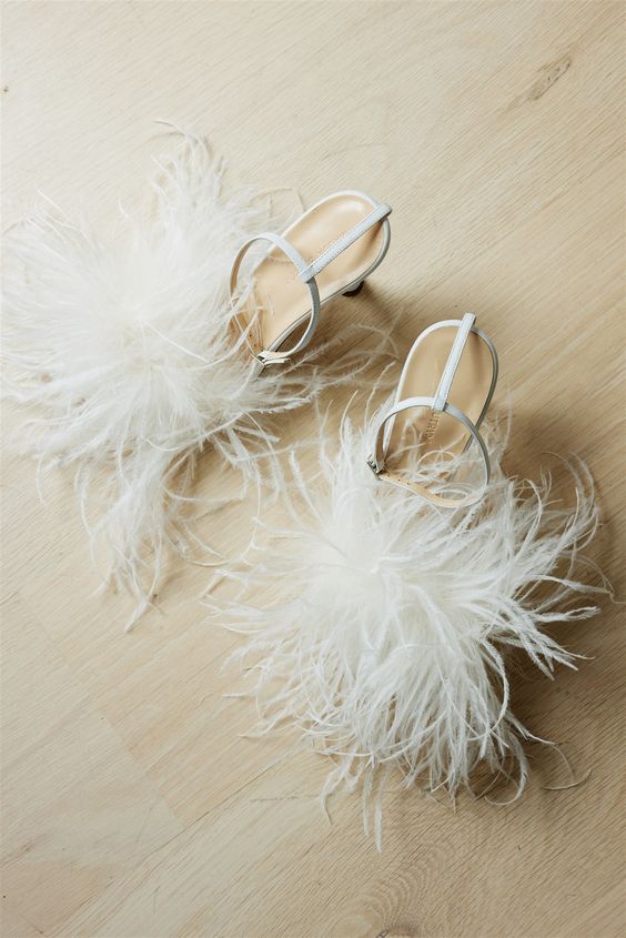 super glam white wedding shoes with ankle straps and feathers are amazing for a fun and glam bridal look