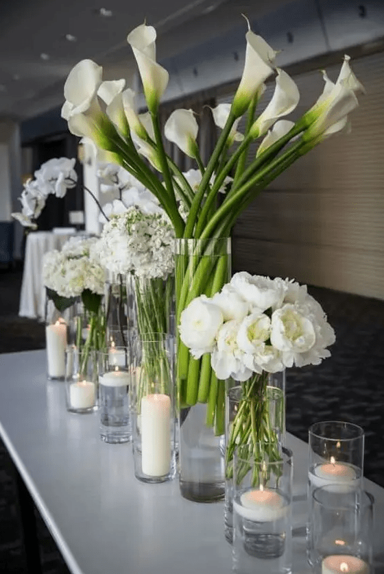 white cluster wedding centerpiece of ponies, callas and hydrangeas and orchids are great for a formal wedding