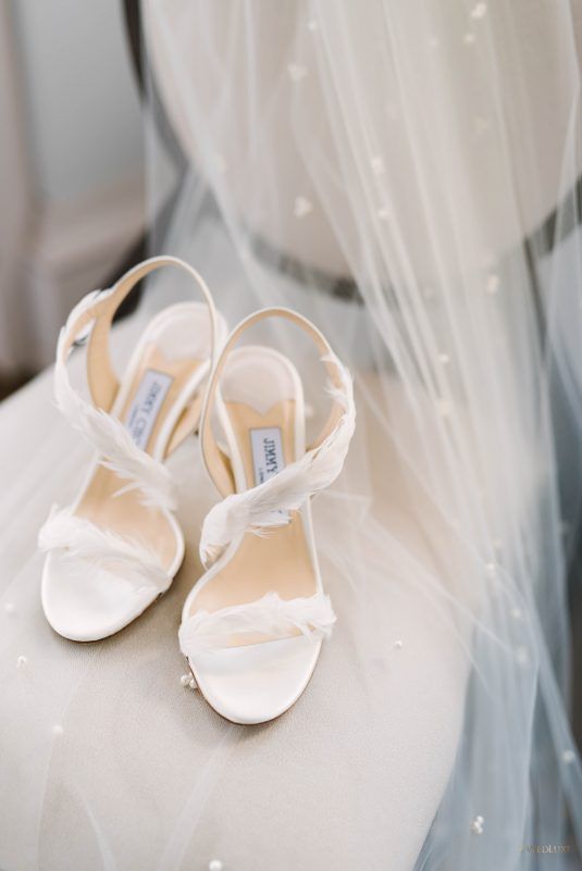 white strappy shoes decorated with feathers are amazing for a spring or summer bridal look