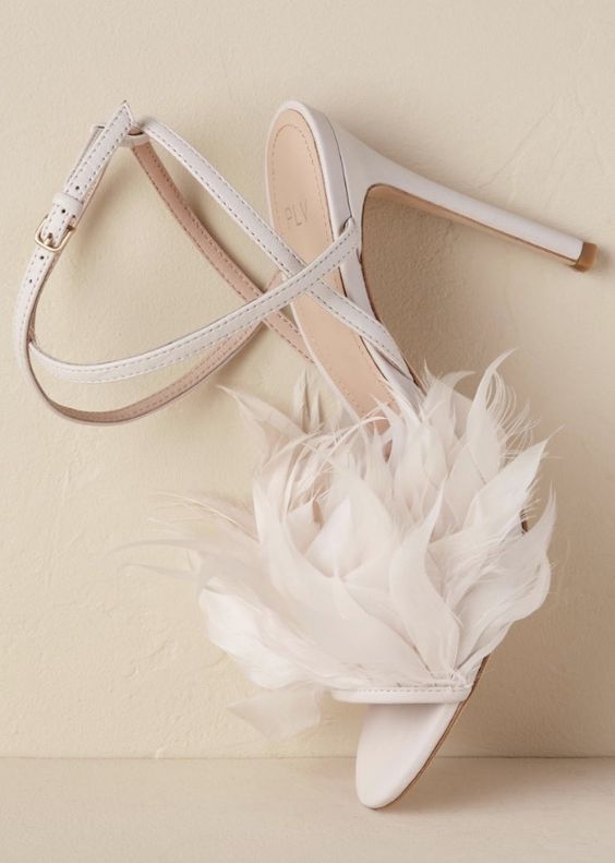 white strappy shoes with learge faux feathers are amazing for a chic and glam bridal look