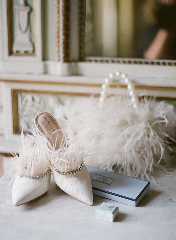 white suede wedding mules with rhinestones and feathers are fashionable and extra bold