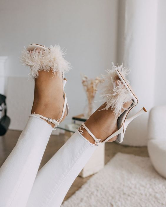 white wedding shoes with feathers and ankle straps are amazing for a glam and fun bridal look