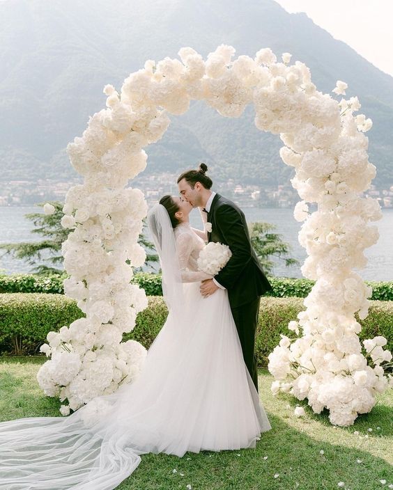 a white hydrangea wedding arch is a cool and catchy decoration that won’t break the bank, it looks chic and cute